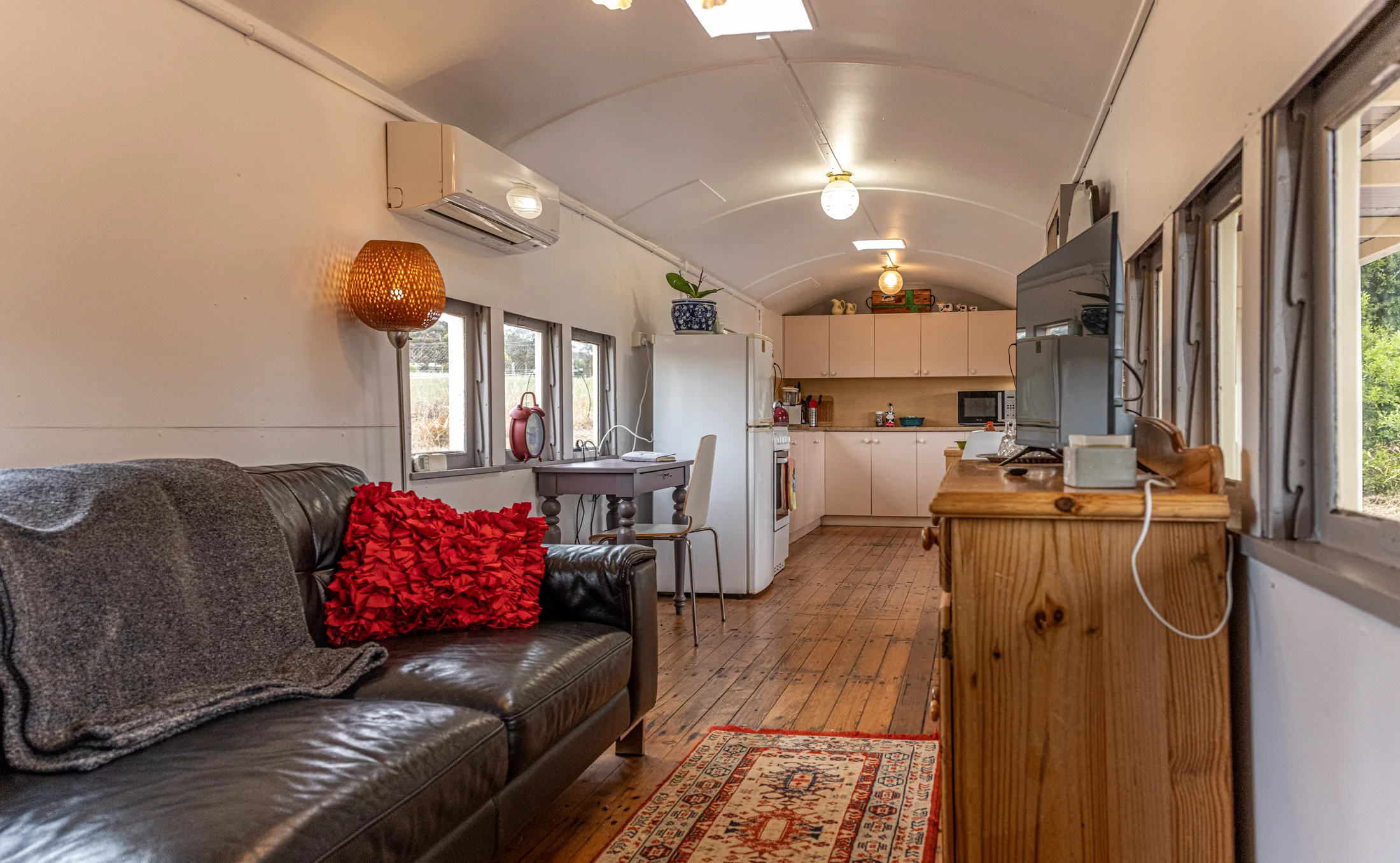 Warm timber floors and living space inside the carriage