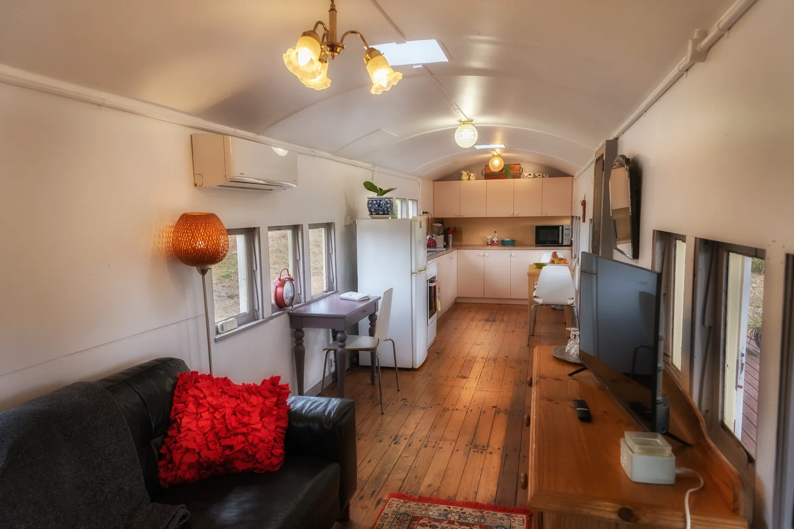 Open-plan lounge and kitchen inside the carriage